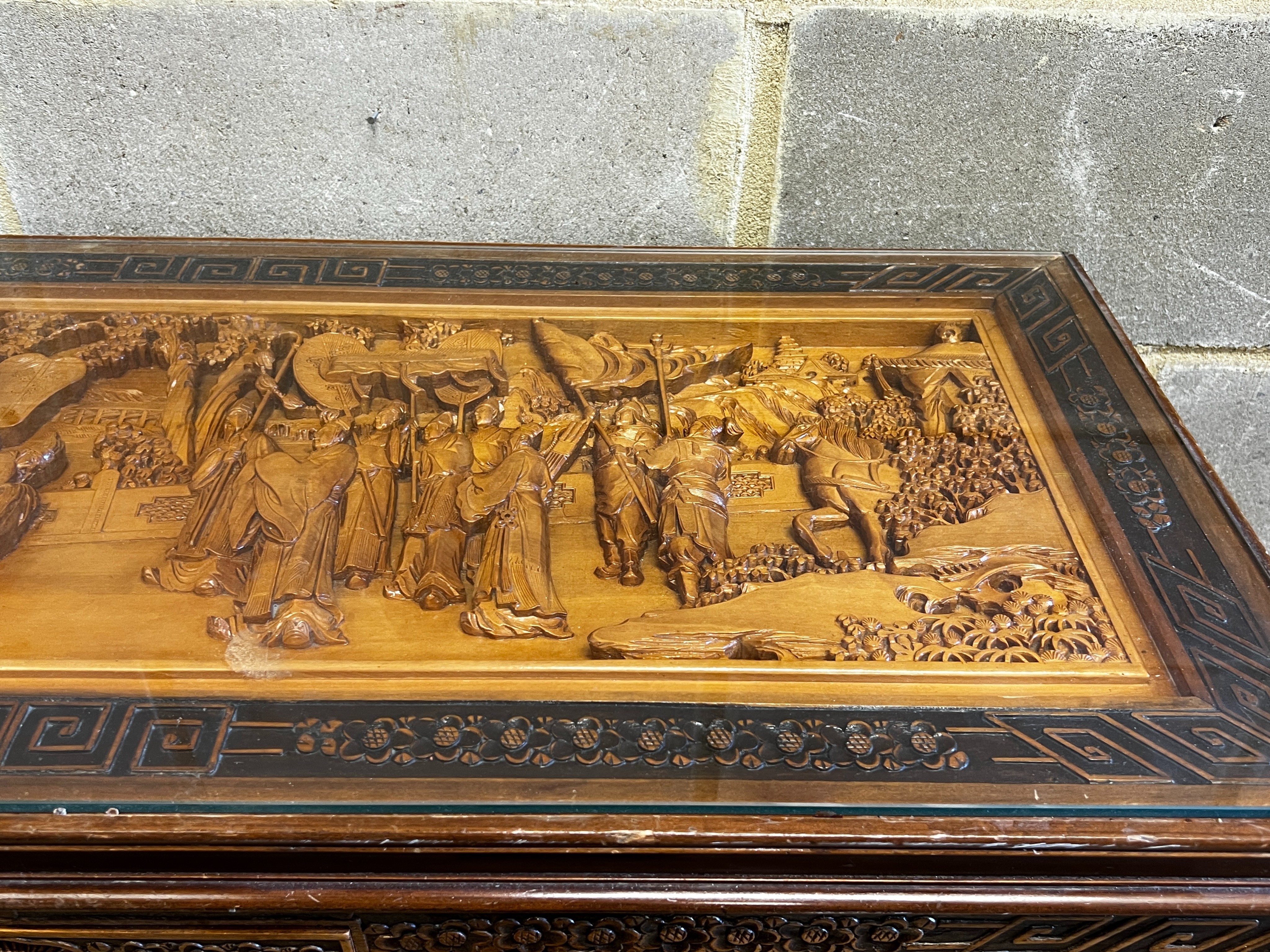 A Chinese carved hardwood low table, length 110cm, depth 43cm, height 36cm